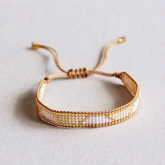 PULSERA TEJIDO BLANCO/CHAMPÁN/ORO